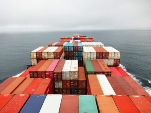 stacked shipping containers on a ship at sea